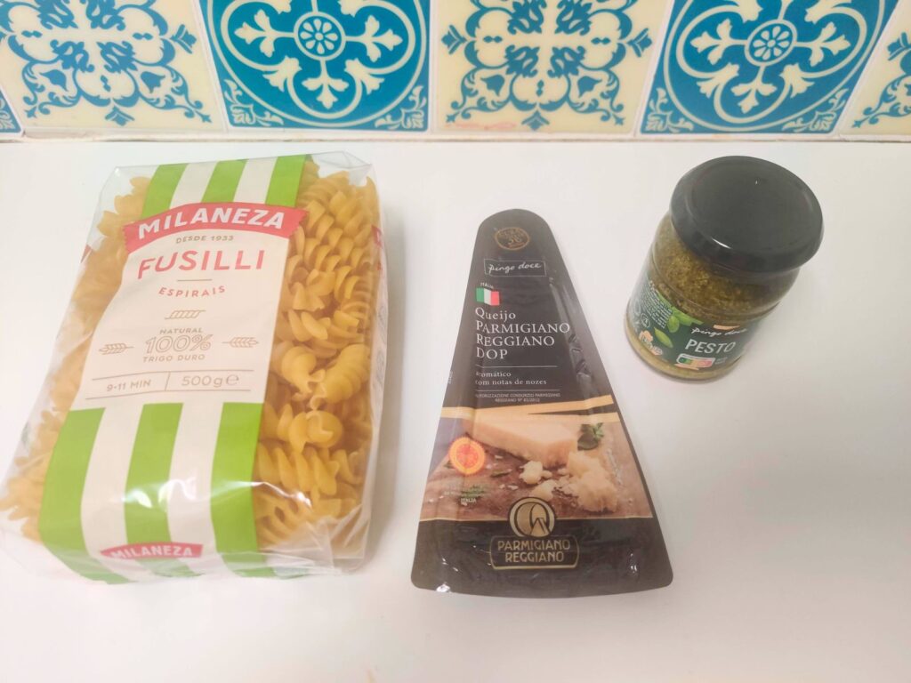 ingredients for pesto with fusilli on a countertop